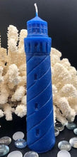 Load image into Gallery viewer, Evoke the beauty of the beach all year long with my 100% beeswax Lighthouse candle. This candle would look great in a nautical themed living space or even a home office. When lit, each candle emits the rich scent of honey and gives off an alluring glow.  Perfect as a gift for the beach lover in your life.  Bring a bit of the sea to them!  Blue shown.  Also available in natural yellow beeswax.
