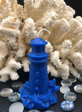 Load image into Gallery viewer, This Lighthouse beeswax candle takes you back to the sea & promises to bring images of the seashore to your dreams.  Perfect for nautical or coastal themed decor or as a gift to the beach lover in your life.  Allow this stunning candle to envelop your room in a warm glow with a sweet honey aroma.  Shown in blue.  Also available in natural yellow beeswax.