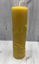 Load image into Gallery viewer, Moose nature scene beeswax candle with mountains, leaves, birds, a stream and the wilderness in the background.