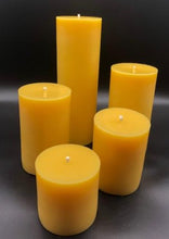 Load image into Gallery viewer, Classic 3" round beeswax pillar candles, available in 5 sizes.  These bright glowing pillars will fill the air with a natural hint of warm, fresh honey, purifying your air all the while. A favorite for housewarming gifts, these handmade candles are perfect for your needs and have a very long burn time!