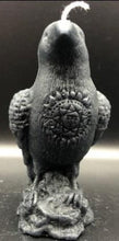 Load image into Gallery viewer, Dark & mysterious, this Raven Beeswax Candle represents a deeper connection between the physical & spiritual world in many cultures. Because of its black plumage, croaking call, and diet of carrion, the raven is often associated with loss and ill omen. Yet, its symbolism is complex. As a talking bird, the raven also represents prophecy and insight. Ravens in stories often act as psychopomps, connecting the material world with the world of spirits.