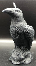 Load image into Gallery viewer, Dark & mysterious, this Raven Beeswax Candle represents a deeper connection between the physical & spiritual world in many cultures. Because of its black plumage, croaking call, and diet of carrion, the raven is often associated with loss and ill omen. Yet, its symbolism is complex. As a talking bird, the raven also represents prophecy and insight. Ravens in stories often act as psychopomps, connecting the material world with the world of spirits.