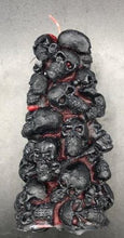 Load image into Gallery viewer, Bleeding Skull Beeswax Candle, piles of skulls and bones with a red leaking core.  Black and red option pictured.