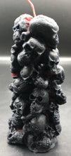 Load image into Gallery viewer, Bleeding Skull Beeswax Candle, piles of skulls and bones with a red leaking core.  Black & Red option pictured.