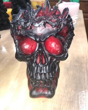 Load image into Gallery viewer, Large, Creepy, gothic skull beeswax candle with leaf crown. Eyes glow when lit. Halloween decor or gothic decor.