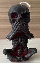 Load image into Gallery viewer, Each beeswax candle measures 4" tall x 2 3/16" wide, and weighs approximately 2 ounces, makin them the perfect size for any room in your home. The three skulls feature a unique design, embodying the classic "see no evil, hear no evil, speak no evil" phrase. Available in a black exterior with red core or a yellow exterior with red core.