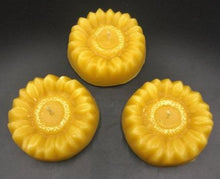 Load image into Gallery viewer, Adorable Sunflower shaped beeswax candle (3 shown). This bright and cheery beeswax candle is sure to brighten everyone's day. A slight shimmer of gold mica in the center adds a touch of whimsey to this summer favorite.