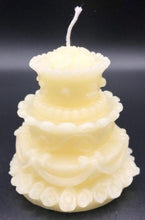 Load image into Gallery viewer, Adorable wedding or birthday cake design. This all natural beeswax candle in the shape of a beautiful cake adorned with roses and ribbons. Handmade in the USA