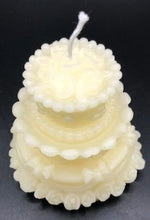 Load image into Gallery viewer, Adorable wedding or birthday cake design. This all natural beeswax candle in the shape of a beautiful cake adorned with roses and ribbons. Handmade in the USA
