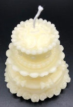Load image into Gallery viewer, Adorable wedding or birthday cake design. This all natural beeswax candle in the shape of a beautiful cake adorned with roses and ribbons. Handmade in the USA