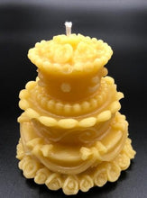 Load image into Gallery viewer, Adorable wedding or birthday cake design. This all natural beeswax candle in the shape of a beautiful cake adorned with roses and ribbons. Handmade in the USA.
