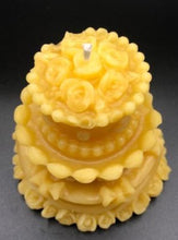 Load image into Gallery viewer, Adorable wedding or birthday cake design. This all natural beeswax candle in the shape of a beautiful cake adorned with roses and ribbons. Handmade in the USA.