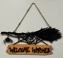 Load image into Gallery viewer, Welcome all the Witches to your home with this Welcome Witches broom sign.  A creepy little spider hangs off the end to add an extra bit of Halloween fun.
