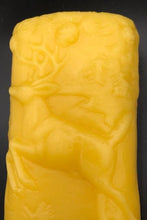 Load image into Gallery viewer, This two sided oval candle depicts a dear in a pine forest jumping on one side and a bear in the forest on the opposite side. The edges of this oval candle are adorned with a pine tree design. Handmade in the USA.