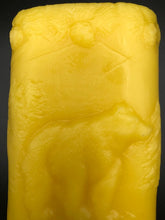 Load image into Gallery viewer, This two sided oval candle depicts a dear in a pine forest jumping on one side and a bear in the forest on the opposite side. The edges of this oval candle are adorned with a pine tree design. Handmade in the USA.