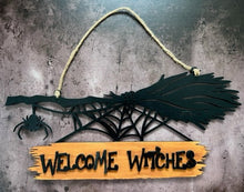 Load image into Gallery viewer, Welcome all the Witches to your home with this Welcome Witches broom sign. A creepy little spider hangs off the end to add an extra bit of Halloween fun. Great for Halloween Parties, gifts for the Halloween lovers in your life or to spruce up your Halloween decor. Witch broom on top with a creeping spider hanging off the side & a spider web below. Wood sign attached to the bottom reads 'Witches Welcome'.