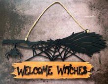 Load image into Gallery viewer, Welcome all the Witches to your home with this Welcome Witches broom sign.  A creepy little spider hangs off the end to add an extra bit of Halloween fun.   Great for Halloween Parties, gifts for the Halloween lovers in your life or to spruce up your Halloween decor.  Witch broom on top with a creeping spider hanging off the side & a spider web below.  Wood sign attached to the bottom reads 'Witches Welcome'.