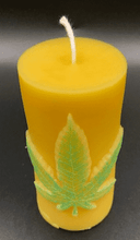 Load image into Gallery viewer, Leaf design beeswax candle. Leaf design on front of this candle shown with green sparkle mica leaf.