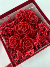 Load image into Gallery viewer, That special someone is sure to feel the love this Valentines Day when they open this fantastic Valentines Day Gift Box Trio.  A stack of 3 red boxes tied with a white ribbon.  Set contains 1 Red Beeswax Rose Pillar Candle, 1 Lavender Bath Bomb & 1 Heart Shaped Goat's Milk Soap in either Lavender or Rose Geranium scents.