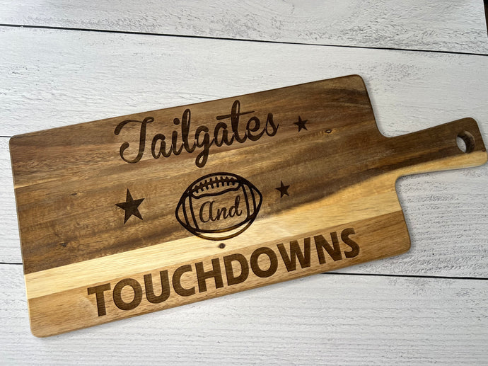 Tailgates and Touchdowns Charcuterie Board with picture of football in the center.  