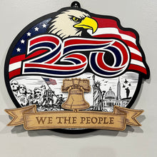 Load image into Gallery viewer, Celebrate America’s 250th Anniversary with this stunning layered laser cut sign, a patriotic tribute to the spirit, strength, and history of the United States. Featuring a majestic bald eagle soaring over a flowing American flag, this eye-catching piece also includes a beautifully engraved scene showcasing iconic American landmarks and heritage-inspired details. 
