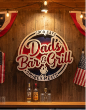 Load image into Gallery viewer, Give Dad's favorite grilling space a little personality with our Dad's Bar &amp; Grill – Good Eats, Smoked Meats Sign! Whether he's the family grill master, king of the smoker, or simply loves spending weekends cooking up something delicious, this handmade sign is a fun way to celebrate his love of BBQ.
