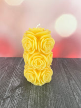 Load image into Gallery viewer, Bring timeless elegance and the warm glow of natural beeswax into your home with this handcrafted Rose Beeswax Pillar Candle. Beautifully sculpted with delicate rose petals, this stunning floral candle creates a cozy ambiance while showcasing the natural beauty of pure American beeswax.

