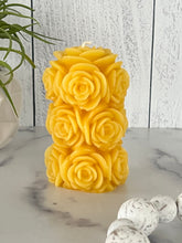 Load image into Gallery viewer, Bring timeless elegance and the warm glow of natural beeswax into your home with this handcrafted Rose Beeswax Pillar Candle. Beautifully sculpted with delicate rose petals, this stunning floral candle creates a cozy ambiance while showcasing the natural beauty of pure American beeswax.
