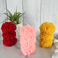 Load image into Gallery viewer, Bring timeless elegance and the warm glow of natural beeswax into your home with this handcrafted Rose Beeswax Pillar Candle. Beautifully sculpted with delicate rose petals, this stunning floral candle creates a cozy ambiance while showcasing the natural beauty of pure American beeswax.
