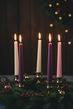 Load image into Gallery viewer, Bring warmth, tradition, and elegance to your holiday gatherings with this festive Advent bundle of pure beeswax taper candles. This set includes a beautiful 10' light pink taper, a 10" white taper and three deep purple 10" tapers (SET OF 5) —perfect for creating a classic Advent wreath or adding seasonal charm to any room. Crafted from 100% natural beeswax, each candle burns drip-free, filling your space with a soft, golden glow and a gentle, all natural,&nbsp; honey fragrance that enhances holiday décor.
