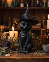 Load image into Gallery viewer, Celebrate the magic of Halloween with this enchanting Black Cat Beeswax Candle, handcrafted from 100% pure American beeswax. Featuring a charming black cat wearing a classic witch's hat adorned with a mystical triple moon symbol and skull centerpiece, this candle is the perfect accent for Halloween displays, gothic home décor, altars, and witchy spaces.
