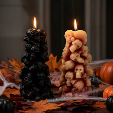 Load image into Gallery viewer, Unleash the spooky vibe with our one-of-a-kind bleeding skull beeswax candle. As it burns, watch in awe as the 'blood' oozes and the skulls roll off onto the plate, adding an eerie touch to your Halloween decorations. The glowing eyes and piles of skulls and bones make this pillar candle a must-have for gothic and fall decor. Perfect for gifting to skull-loving friends or for adding a touch of horror to any room. Get yours now and bring the creepy factor to your home!
