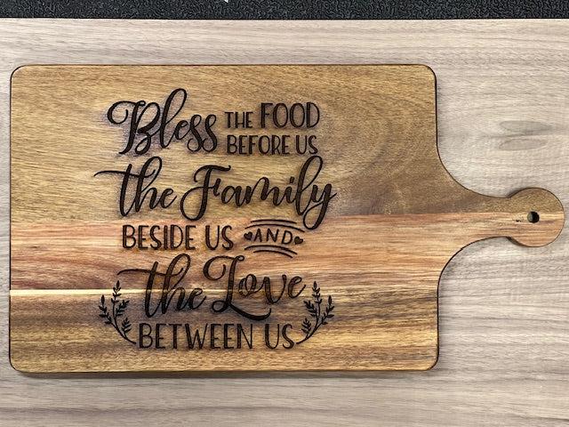 This exquisite Acacia Wood Cutting Board, a versatile and stylish addition to your kitchen or entertaining space. Crafted from high-quality acacia wood, this cutting board not only provides a durable surface for all your slicing and dicing needs but also doubles as a charming charcuterie board for serving appetizers with flair.