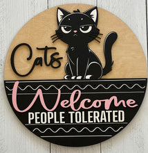 Load image into Gallery viewer, Let guests know exactly where they stand with this hilarious “Cats Welcome, People Tolerated” door hanger sign! Featuring an adorable black cat giving the ultimate snide side-eye look, this fun and sassy sign is the perfect addition to any cat lover’s home décor.

