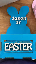 Load image into Gallery viewer, Make this Easter unforgettable with our Adorable Wood Crate Easter Basket, personalized with your child&#39;s name on top. Elevate the joy of the egg hunt and create lasting memories with these charming, customized Easter baskets designed just for your little ones.
