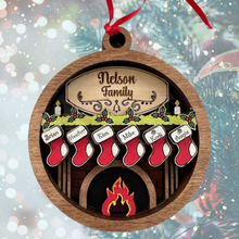 Load image into Gallery viewer, Celebrate everyone who makes your house a home with this Personalized Family Christmas Ornament featuring a cozy fireplace, customized stockings, and your family name on the mantel. This hand-painted keepsake is a beautiful way to celebrate your family and create a Christmas ornament you'll look forward to hanging on the tree year after year.
