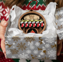 Load image into Gallery viewer, Celebrate everyone who makes your house a home with this Personalized Family Christmas Ornament featuring a cozy fireplace, customized stockings, and your family name on the mantel. This hand-painted keepsake is a beautiful way to celebrate your family and create a Christmas ornament you'll look forward to hanging on the tree year after year.
