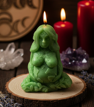 Load image into Gallery viewer, Honor the beauty, balance, and abundance of nature with this handcrafted Gaia Mother Earth Beeswax Candle. Symbolizing the nurturing spirit of Mother Earth, this stunning candle depicts Gaia gently holding the Earth in her hands beneath the sun, moon, and stars. Flowing vines and leaves intertwine throughout her body, while the infinity symbol on her third eye represents wisdom, spiritual connection, and the endless cycle of life.
