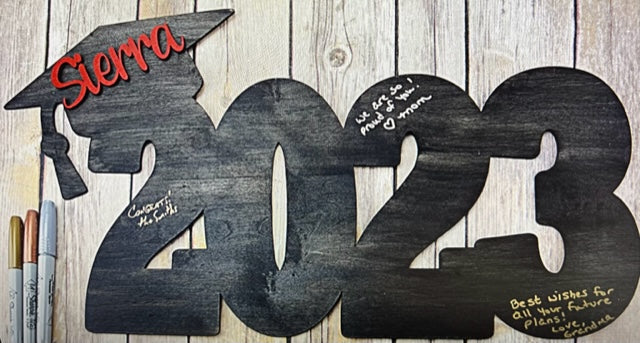 Celebrate your graduate with this personalized wooden graduation sign. An ideal alternative to a traditional guestbook, it features their graduation year, making it a great photo prop for the special day. Show your support in style with this meaningful keepsake.