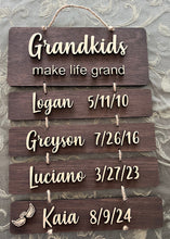 Load image into Gallery viewer, Add your grandkid&#39;s names to this beautiful Grandkids Make Life Grand Sign to create a lasting heirloom your loved ones will treasure.&nbsp; This adorable sign reads Grandkids make life grand and lists each grandchild in order with their birthdate.&nbsp; Angel wings can be added upon request.
