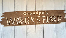 Load image into Gallery viewer, Transform your workshop into a space that truly reflects your craftsmanship with our extraordinary Workshop Sign. Welcome one and all to your creative haven and personalize this sign with your favorite craftsman&#39;s name prominently displayed at the top. Crafted with care, this sign is more than just an entrance statement; it&#39;s a celebration of your passion for creating.
