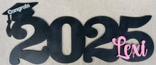 Load image into Gallery viewer, Celebrate your graduate with this personalized wooden graduation sign. An ideal alternative to a traditional guestbook, it features their graduation year, making it a great photo prop for the special day. Show your support in style with this meaningful keepsake.
