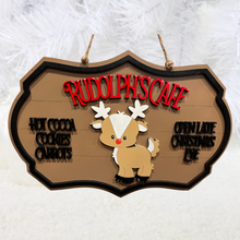 Load image into Gallery viewer, Give your decor a festive twist with this Rudolph&#39;s Cafe sign.&nbsp; This adorable sign adds a touch of whimsey to any coffee bar or kitchen area offering Hot Cocoa, Cookies, and Carrots &amp; adds that you&#39;re Open Late Christmas Eve.
