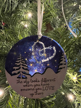 Load image into Gallery viewer, This beautiful The Sky Looks Different ornament is sure to become a cherished memorial to those we love.&nbsp; The background is made of transparent blue acrylic or stary sky acrylic to allow the light to shine through the ornament for a beautiful remembrance.&nbsp; Available in 2 styles and may be customized.
