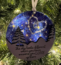 Load image into Gallery viewer, This beautiful The Sky Looks Different ornament is sure to become a cherished memorial to those we love.&nbsp; The background is made of transparent blue acrylic or stary sky acrylic to allow the light to shine through the ornament for a beautiful remembrance.&nbsp; Available in 2 styles and may be customized.
