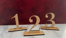 Load image into Gallery viewer, Make your wedding, anniversary, or engagement party unforgettable with these elegant table number signs. Designed to add both beauty and functionality, these signs help your guests easily find their seats while enhancing your event’s décor.
