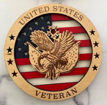 Load image into Gallery viewer, Celebrate the heroes that fought for our freedom with these Military Signs. &nbsp;These 9” round signs display a flag background and your choice of military insignias on the front. &nbsp;The perfect way to thank the veterans or active duty hero’s in your life. &nbsp;
