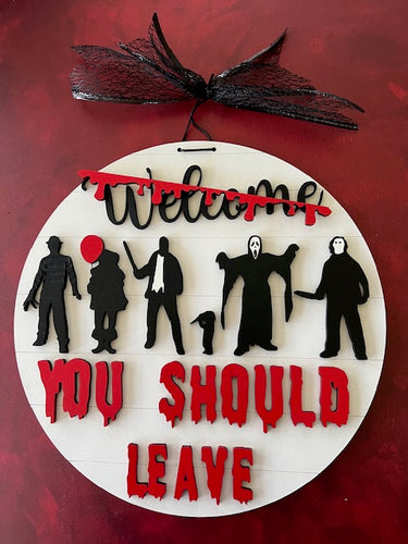 Step up your Halloween decor with this You Should Leave Horror Welcome Sign.  Scary villains' 'welcome' guests warning You Should Leave.  Welcome is slashed with a bloody gash as the villains' await your guests. 