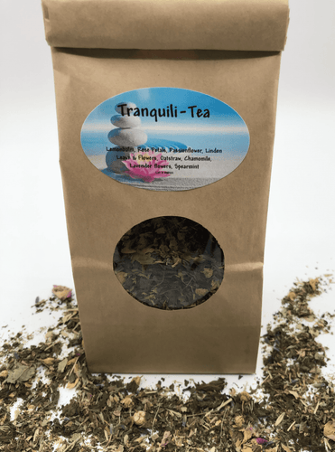 Tranquili-Tea herbal tea bag with loose leaf tea around the base.  Relaxing, nerve calming herbs.