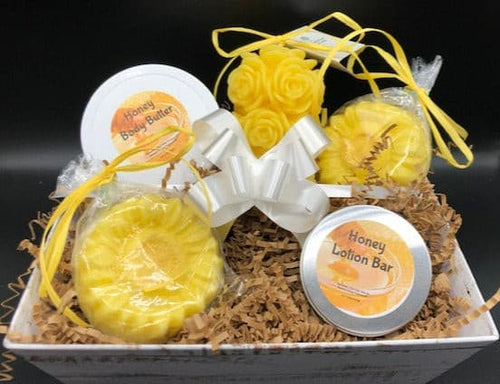 This adorable gift basket is sure to brighten anyone's day!  Packed full of amazing products to sooth away that special someone's cares & add a bit of sunshine to their days.  Set contains one rose pillar candle, one honey body butter, two sunflower goat's milk soaps and one honey lotion bar all packed up and ready to go.  Perfect for Mother's Day gifts, Birthday gifts, Get Well Soon gifts or just to let someone know you're thinking of them.  